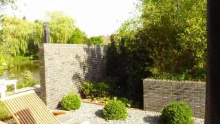 Moderne tuin aanleggen in Tilburg. Welke materialen zijn verwerkt, split antrasiet 16/30 strenperstenen zwart. natuursteen 40x60x3